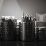 a black and white photo of toothbrushes and toothpaste